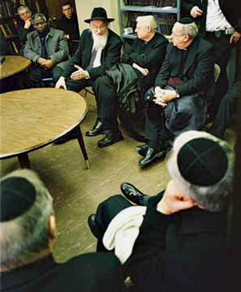 Catholic prelates wearing yarmulkes being taught by a rabbi